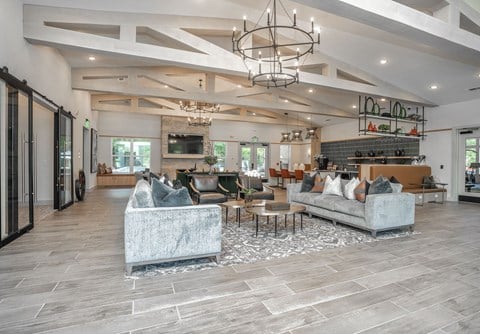 a large living room with couches and a table